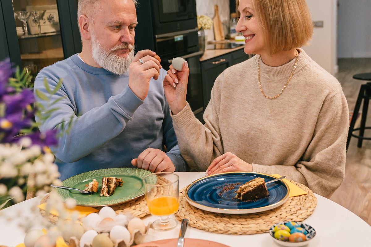 Smiling older couple sharing a morning meal at a kitchen table